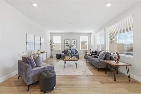 a living room with furniture and wooden floor