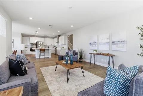 a living room with furniture and kitchen view