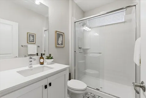 a bathroom with a sink toilet and shower