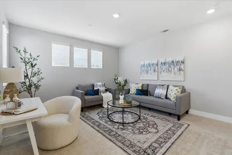 a living room with furniture and a potted plant