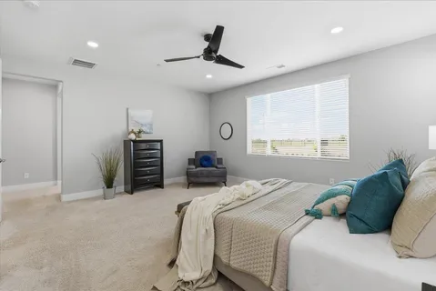 a bedroom with a bed next to a window