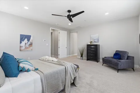 a bedroom with bed and a couch