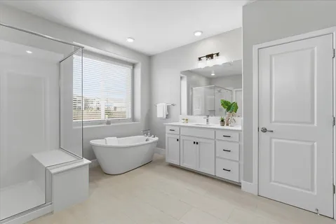 a bathroom with a granite countertop sink mirror and bathtub