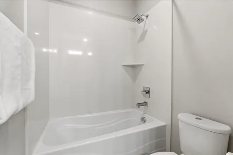 a bathroom with a bathtub and a toilet