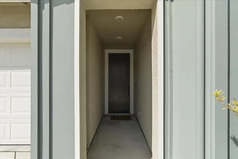 a view of a hallway with a wooden door