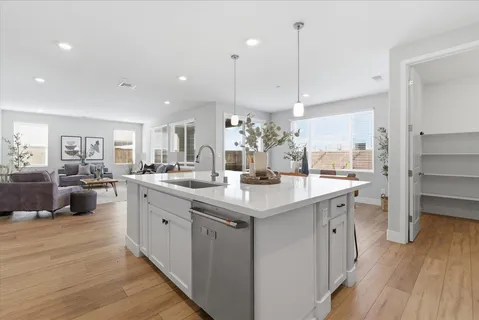 a kitchen with counter top space a sink appliances and cabinets