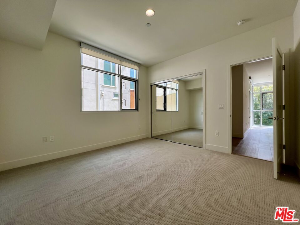 11715 Bellagio Road, Unit 204 Los Angeles, CA 90049 - Photo 14 of 27 an empty room with windows and closet