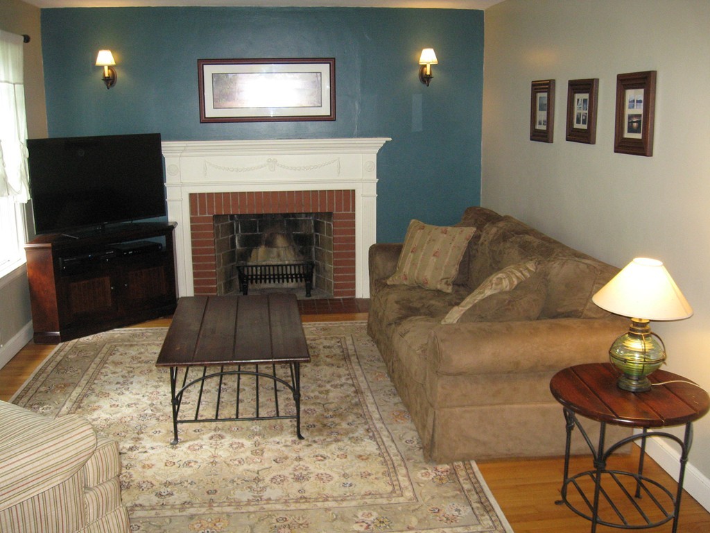 34 Mayflower Road Springfield, MA 01118 - Photo 18 of 23 a living room with furniture and a fireplace