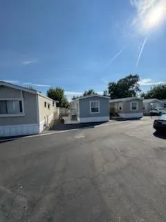 a kitchen with stainless steel appliances granite countertop a sink and a refrigerator