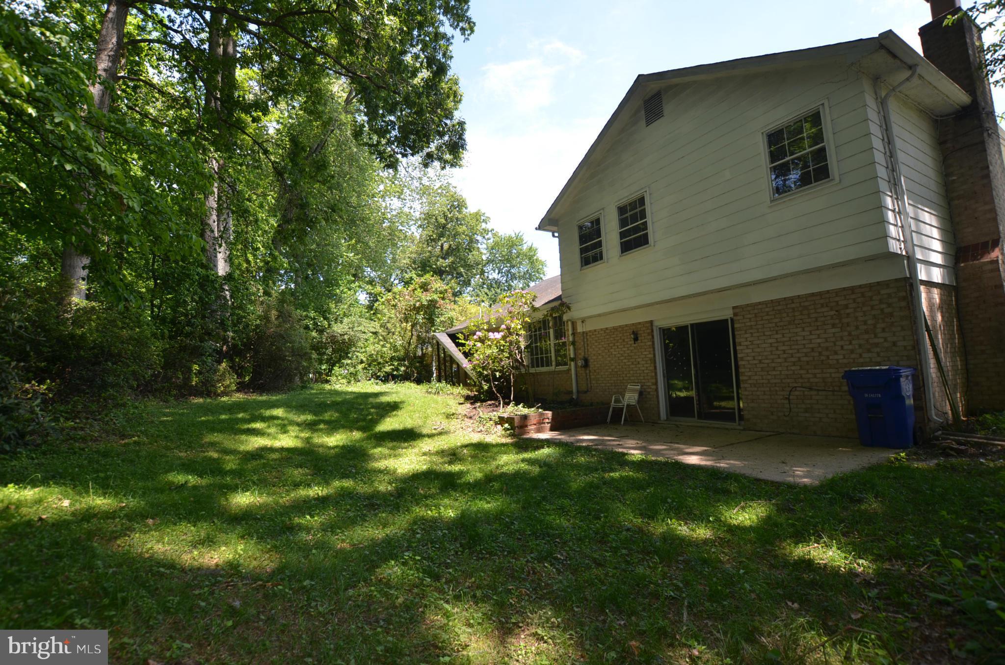 11810 Coldstream Drive Potomac, MD 20854 - Photo 13 of 13 a backyard of a house with table and chairs