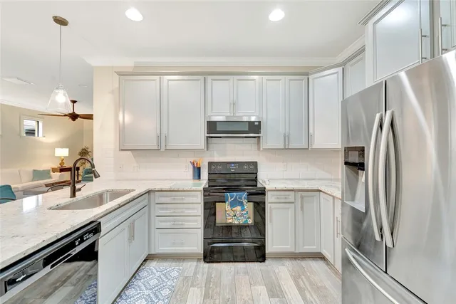a kitchen with a sink stainless steel appliances and cabinets