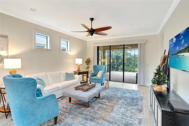a living room with furniture and a floor to ceiling window
