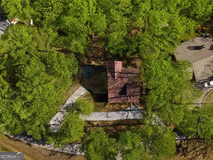 an aerial view of a house with a yard