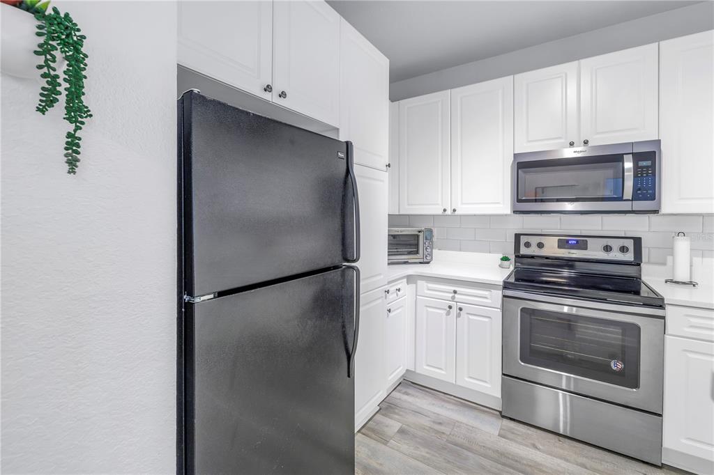 4221 West Spruce Street, Unit 1325 Tampa, FL 33607 - Photo 11 of 35 a kitchen with a refrigerator stove and microwave