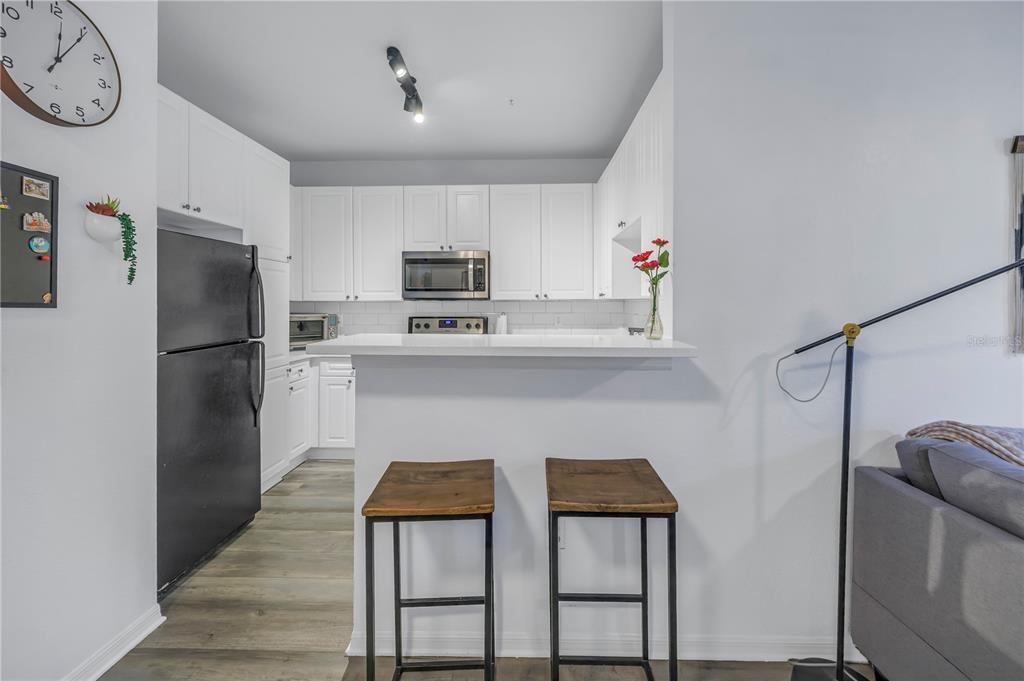 4221 West Spruce Street, Unit 1325 Tampa, FL 33607 - Photo 12 of 35 a kitchen with stainless steel appliances a refrigerator sink and microwave