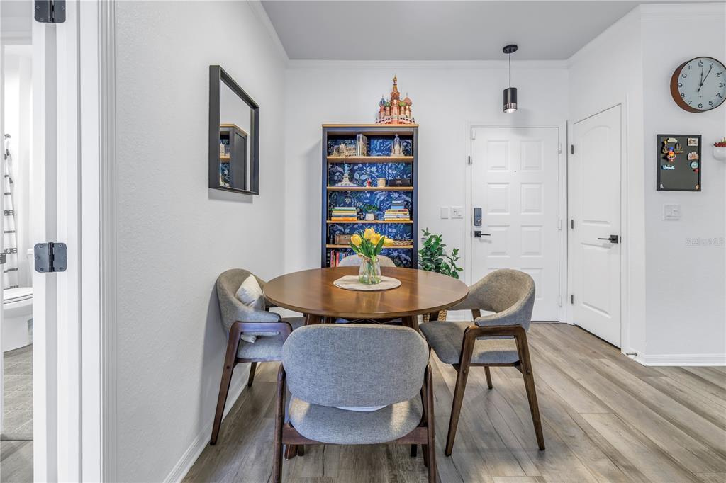 4221 West Spruce Street, Unit 1325 Tampa, FL 33607 - Photo 13 of 35 a view of a dining room with furniture and wooden floor