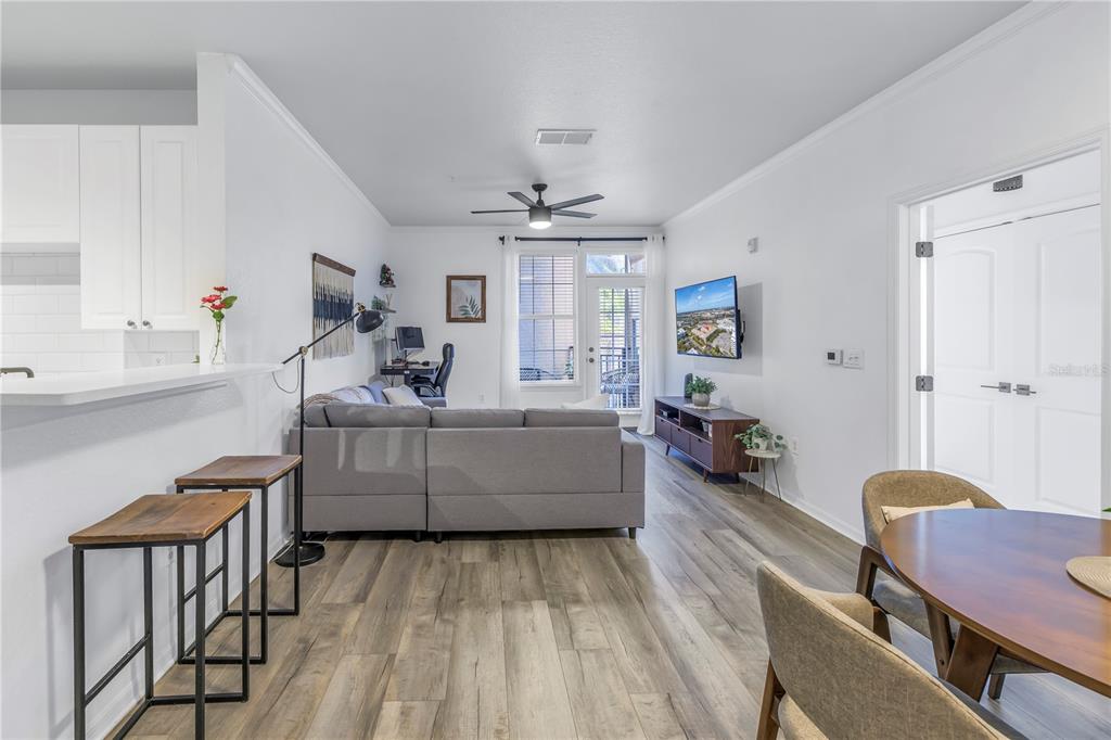 4221 West Spruce Street, Unit 1325 Tampa, FL 33607 - Photo 15 of 35 a living room with furniture and a wooden floor