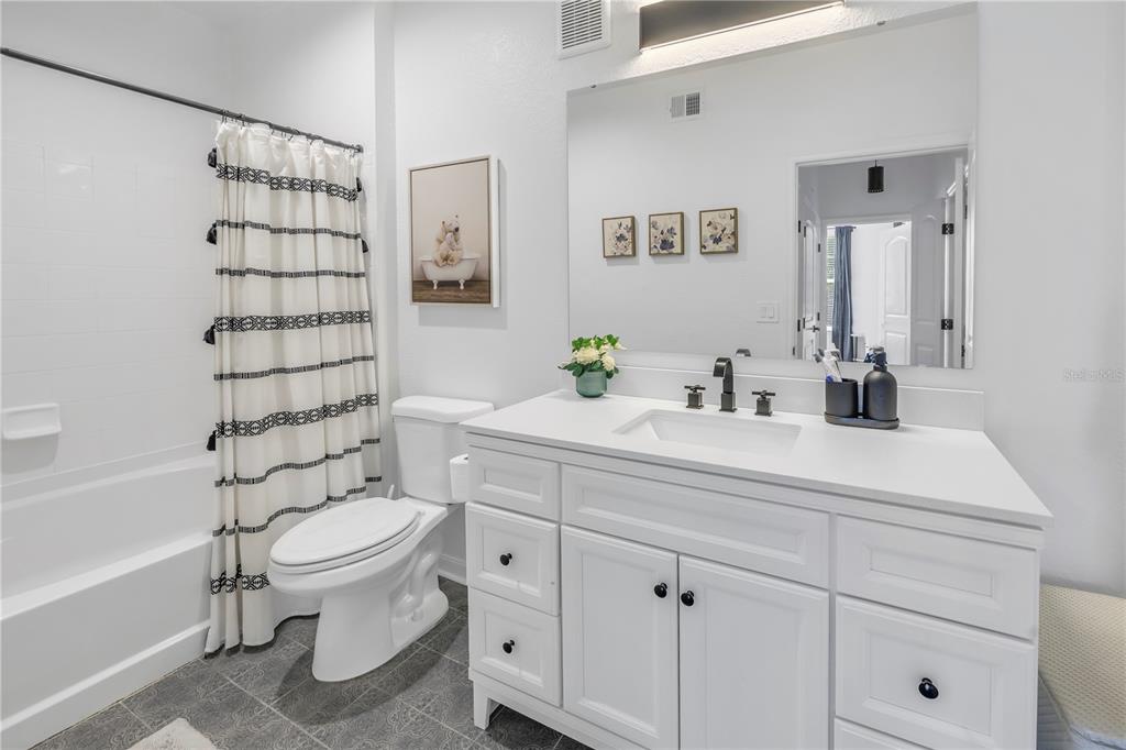 4221 West Spruce Street, Unit 1325 Tampa, FL 33607 - Photo 18 of 35 a bathroom with a sink toilet and shower