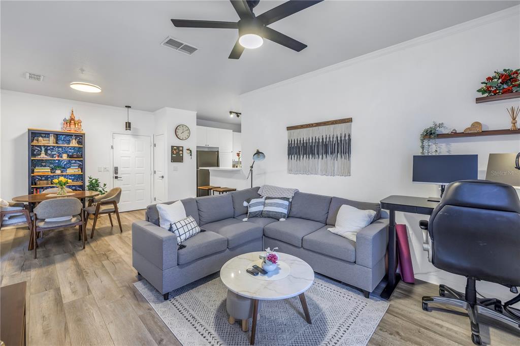 4221 West Spruce Street, Unit 1325 Tampa, FL 33607 - Photo 2 of 35 a living room with furniture a rug and a dining table