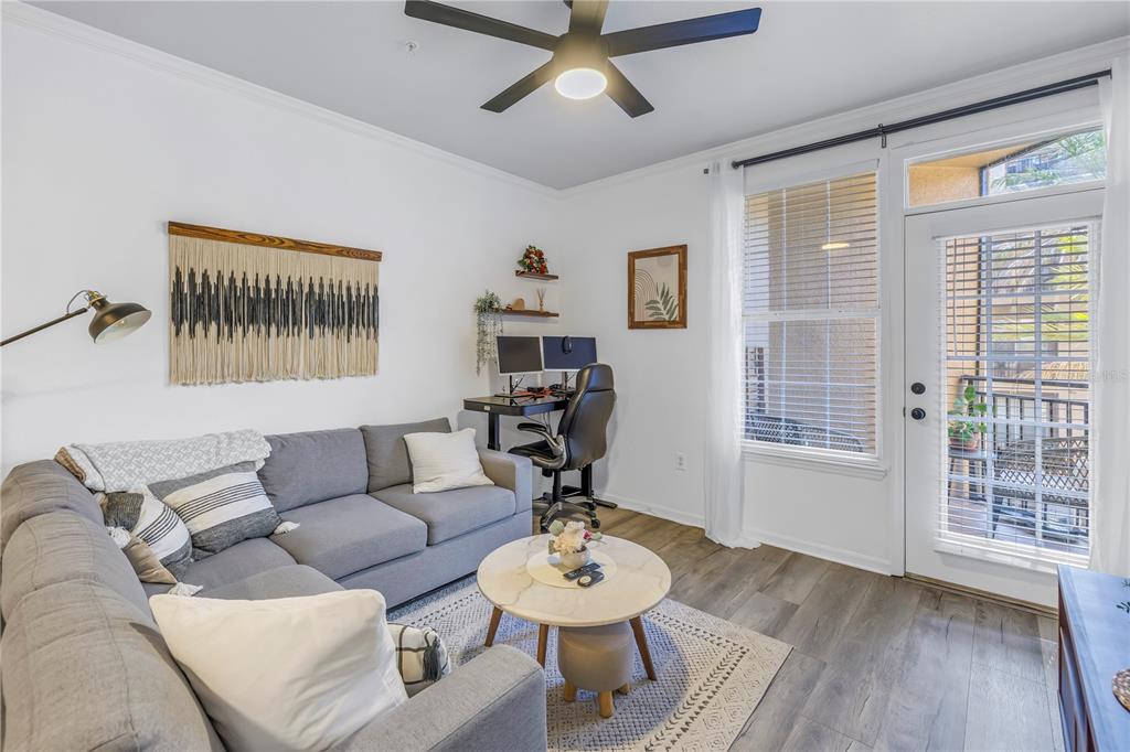 4221 West Spruce Street, Unit 1325 Tampa, FL 33607 - Photo 3 of 35 a living room with furniture and a large window