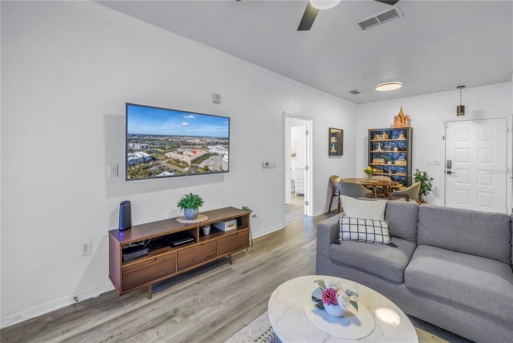 4221 West Spruce Street, Unit 1325 Tampa, FL 33607 - Photo 5 of 35 a living room with furniture and a wooden floor