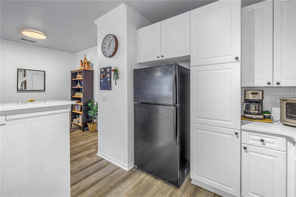 4221 West Spruce Street, Unit 1325 Tampa, FL 33607 - Photo 9 of 35 a white refrigerator freezer and a stove sitting inside of a kitchen