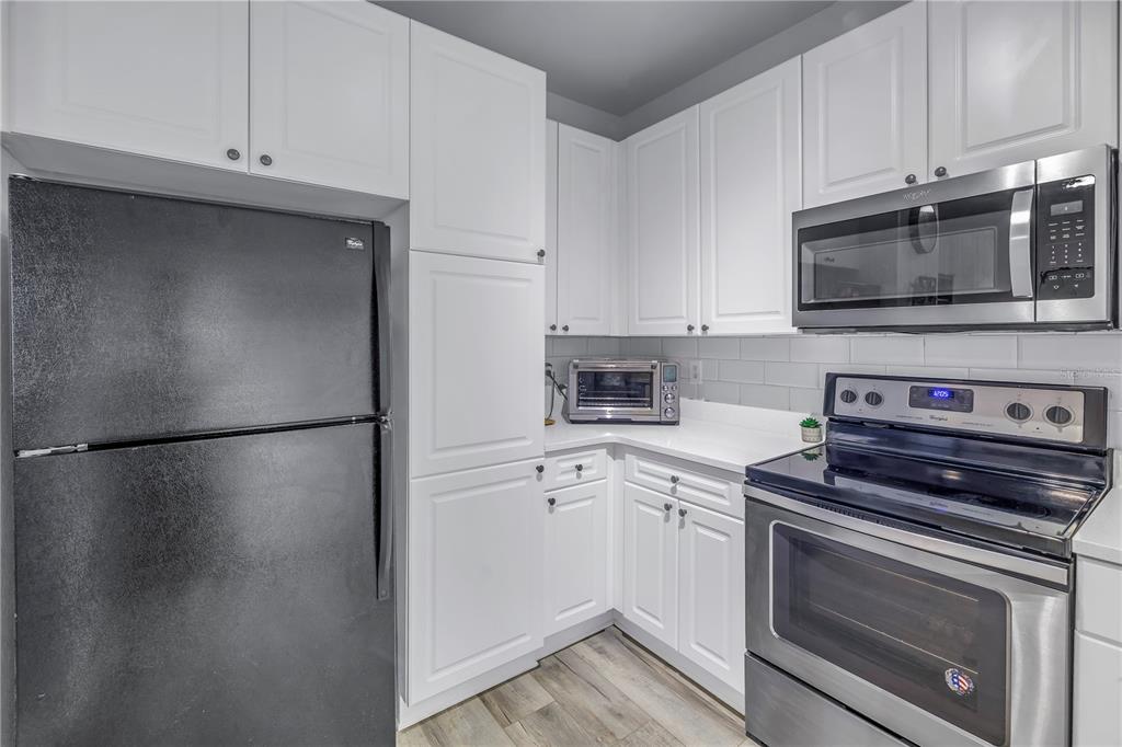 4221 West Spruce Street, Unit 1325 Tampa, FL 33607 - Photo 10 of 35 a kitchen with cabinets and stainless steel appliances