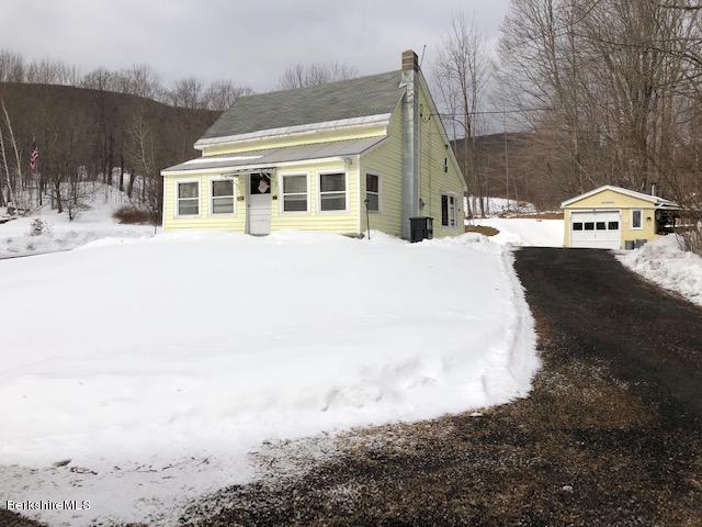 127 Welch Road Clarksburg, MA 01247 - Photo 1 of 6 a front view of a house with a yard covered with snow