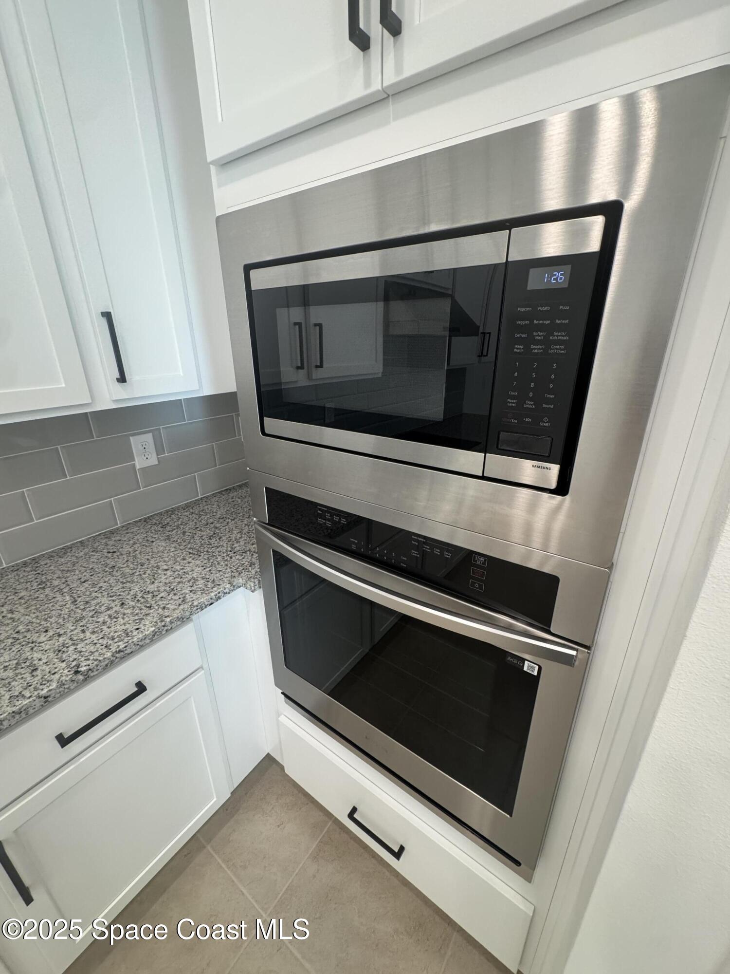 1041 Canfield Circle Palm Bay, FL 32909 - Photo 11 of 57 a stove top oven sitting inside of a kitchen