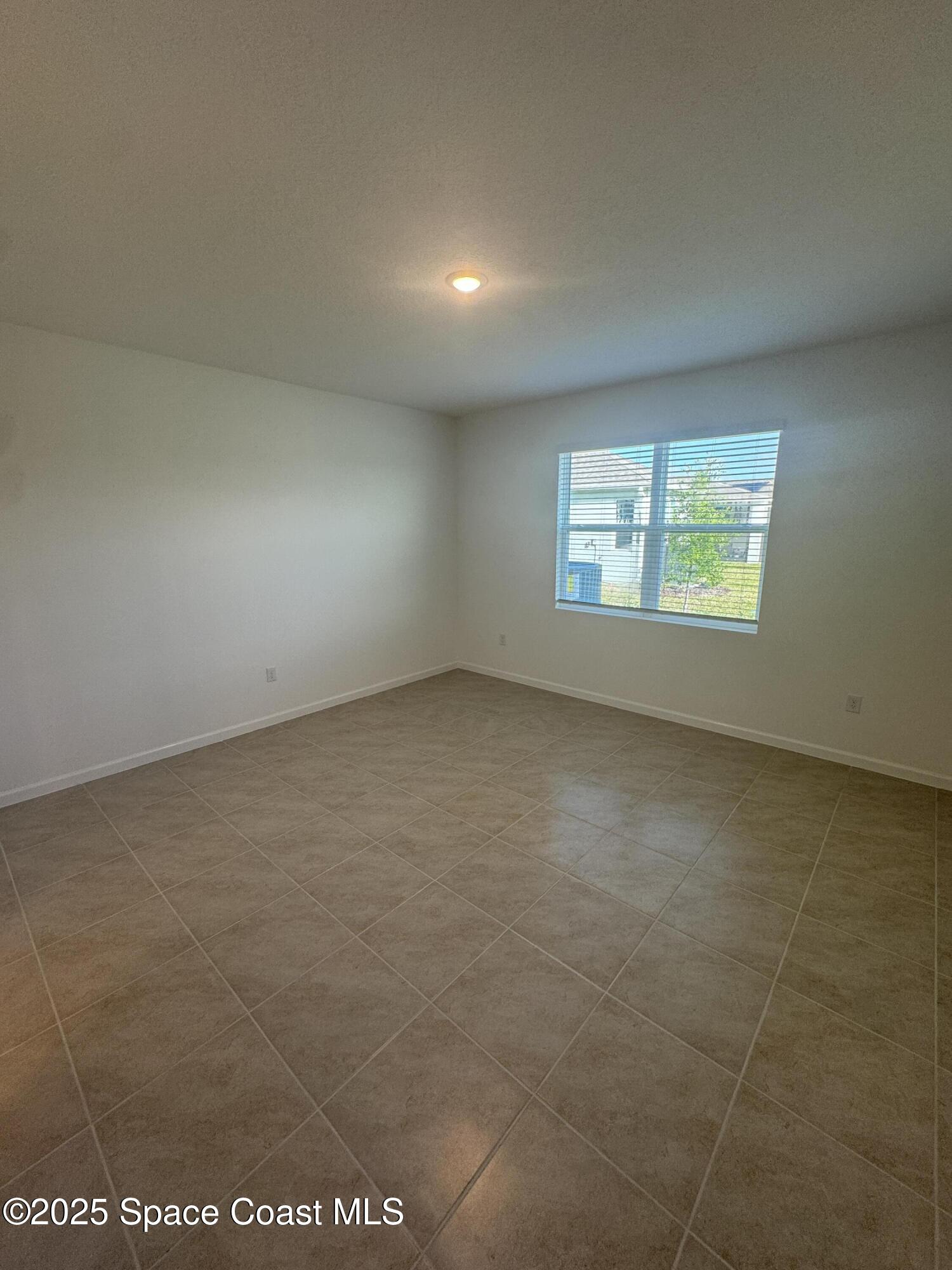 1041 Canfield Circle Palm Bay, FL 32909 - Photo 15 of 57 an empty room with windows
