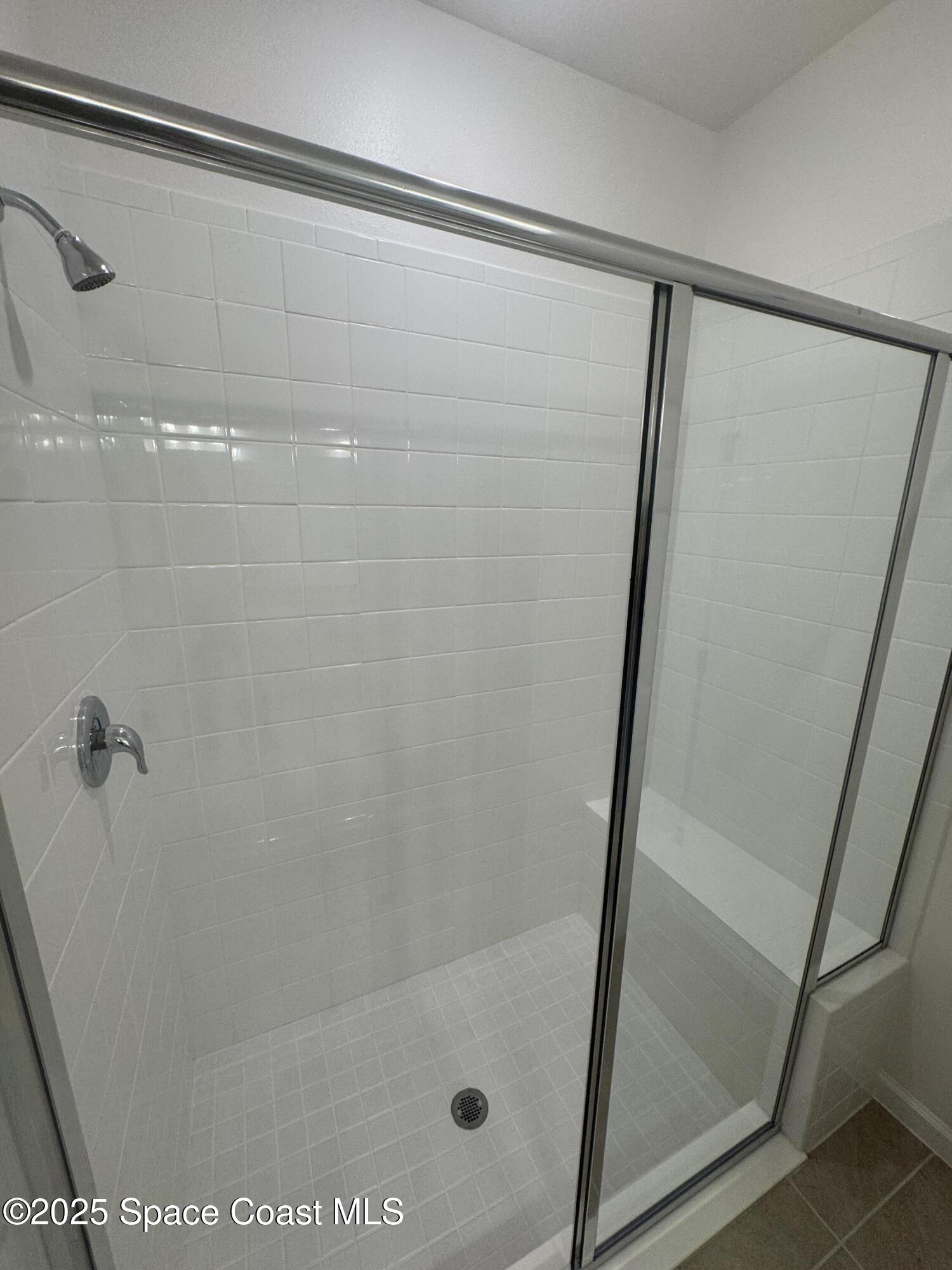 1041 Canfield Circle Palm Bay, FL 32909 - Photo 18 of 57 a bathroom with a glass shower door