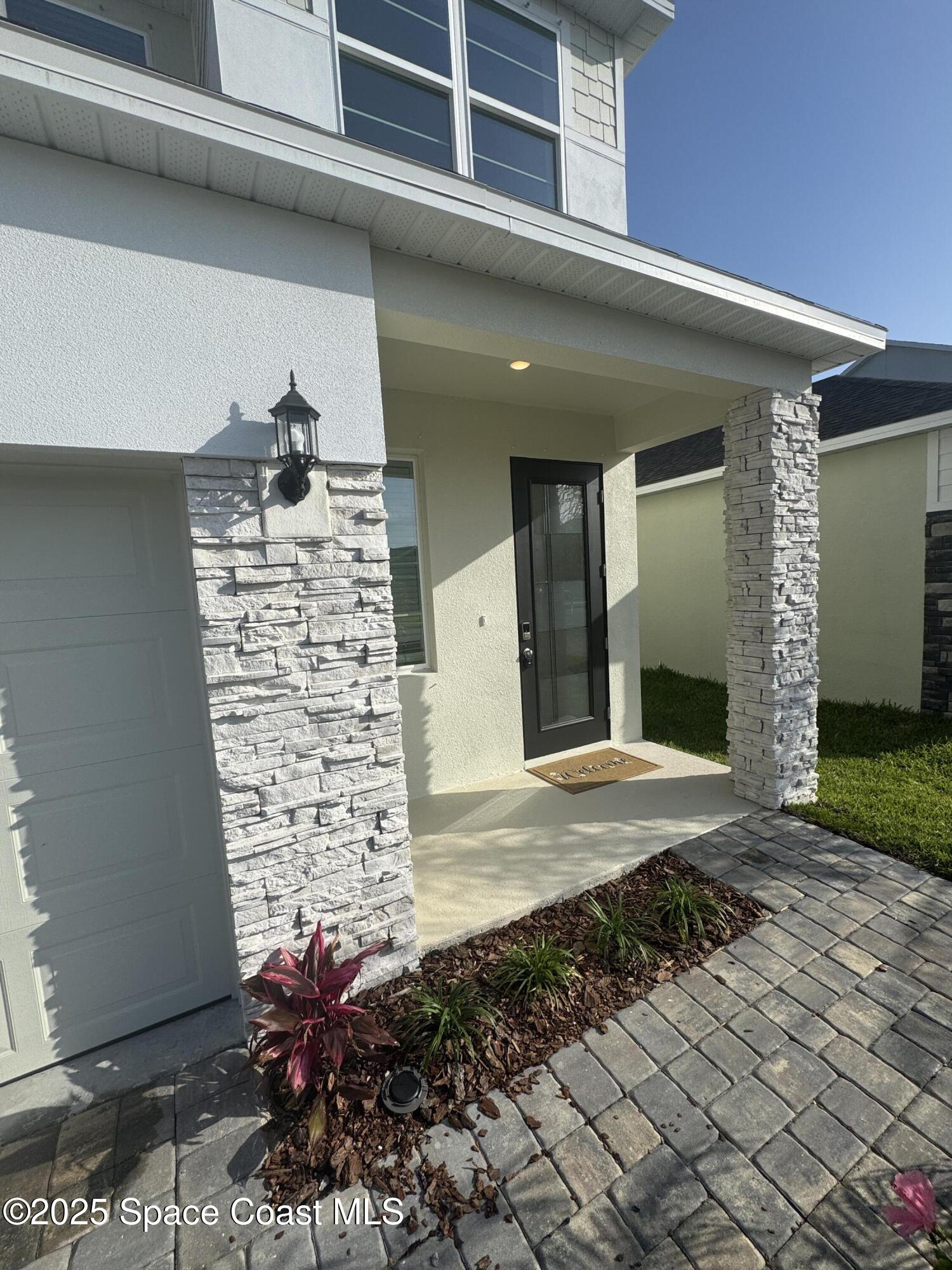 1041 Canfield Circle Palm Bay, FL 32909 - Photo 2 of 57 a view of a house with a door and a yard