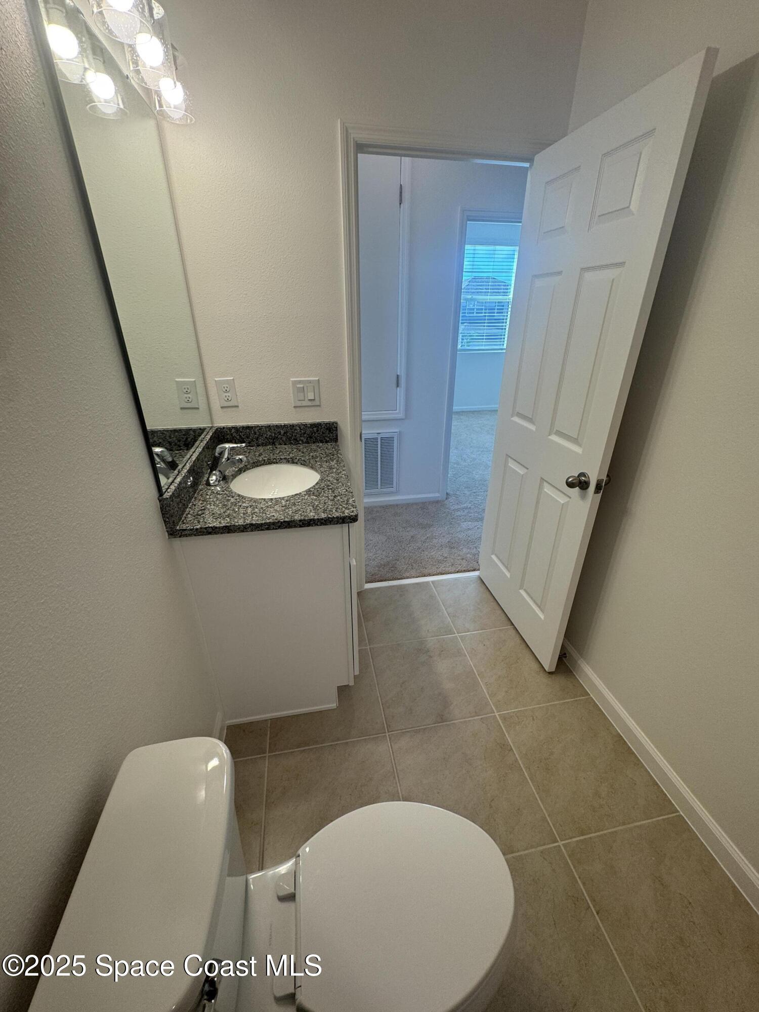 1041 Canfield Circle Palm Bay, FL 32909 - Photo 39 of 57 a bathroom with a sink and toilet
