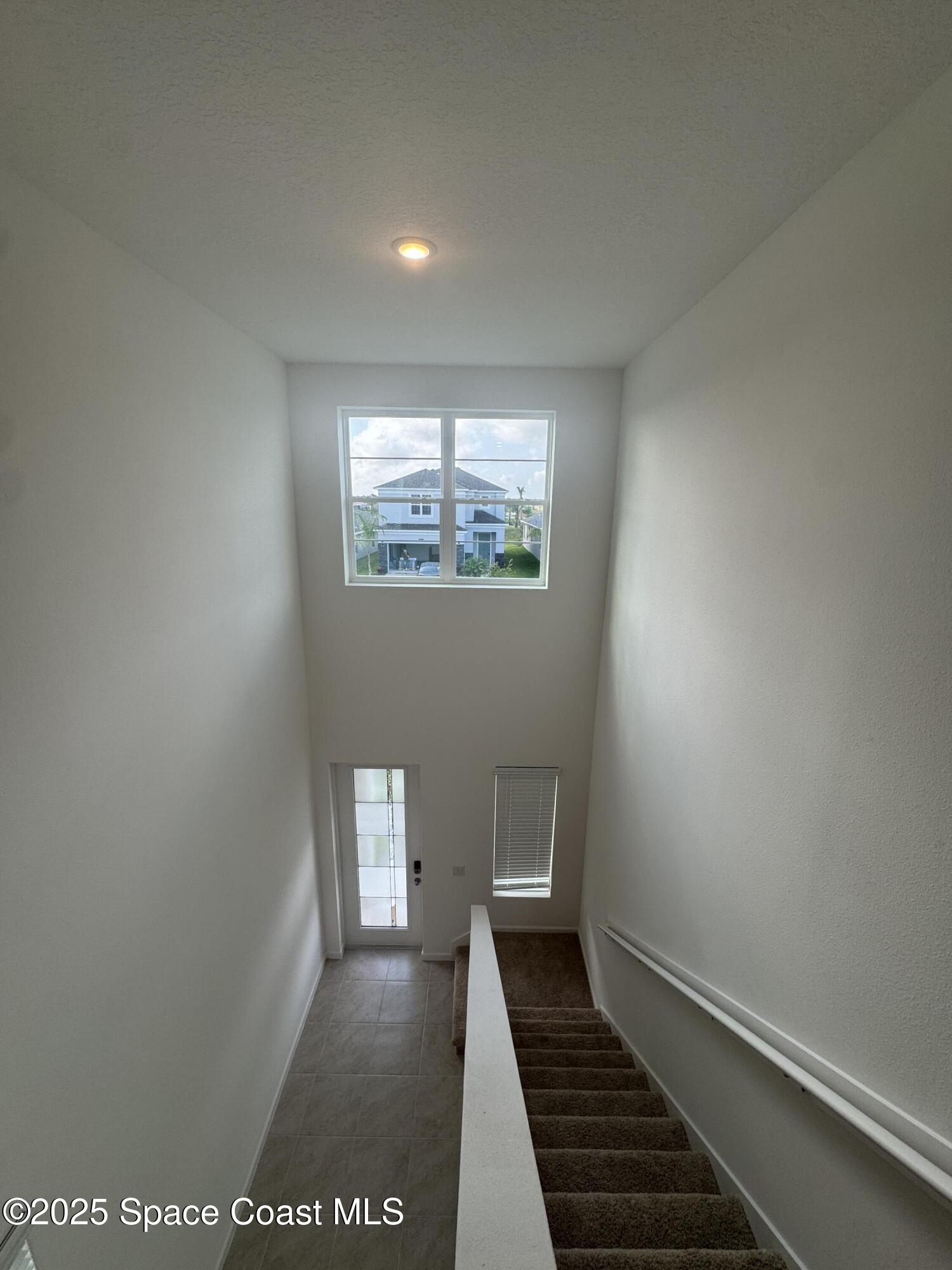 1041 Canfield Circle Palm Bay, FL 32909 - Photo 40 of 57 a view of a hallway with wooden floor and a window
