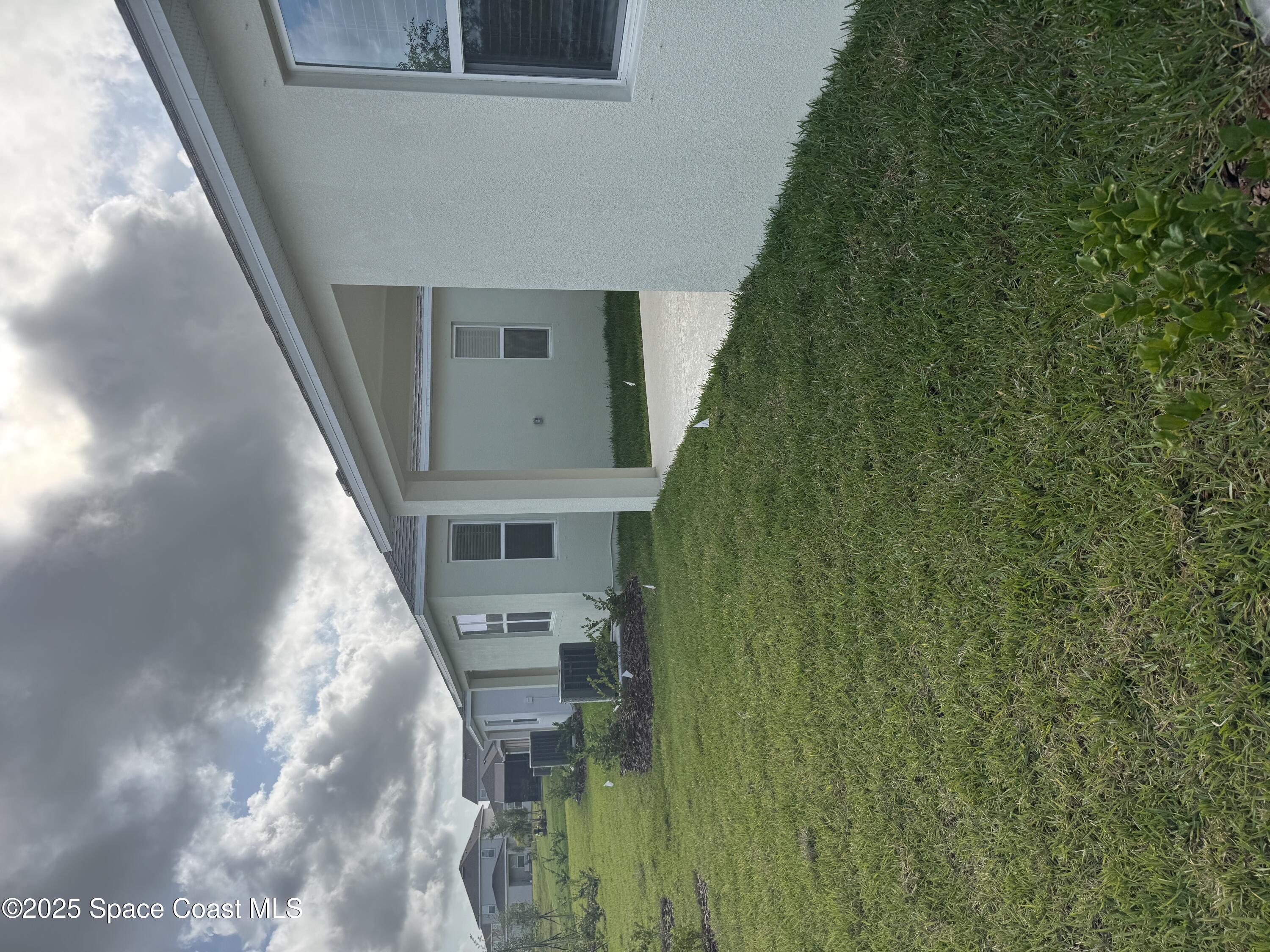 1041 Canfield Circle Palm Bay, FL 32909 - Photo 44 of 57 a balcony with a yard