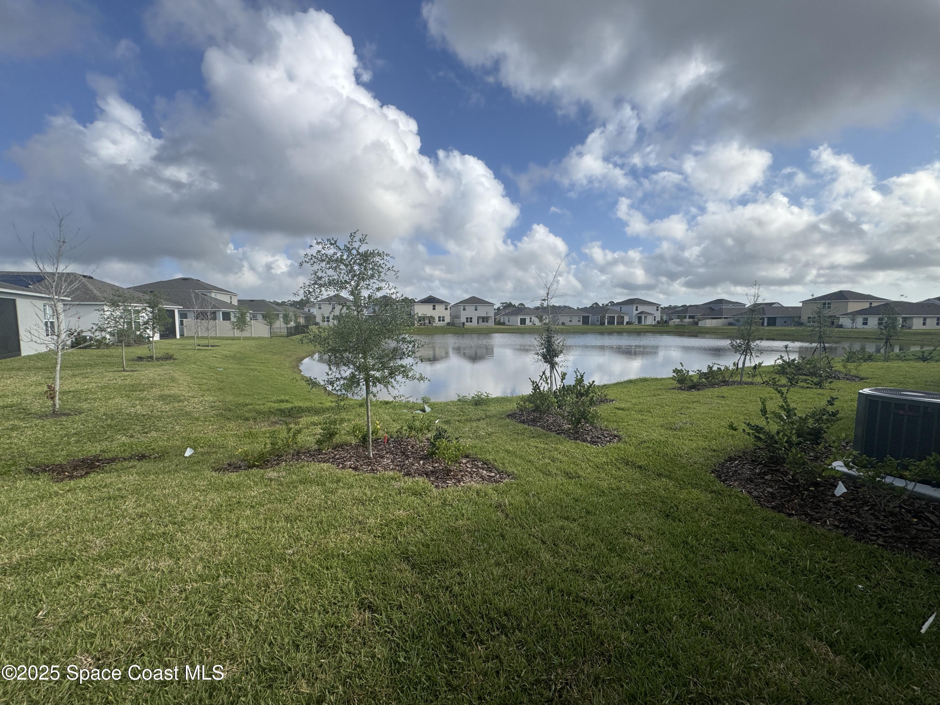 1041 Canfield Circle Palm Bay, FL 32909 - Photo 47 of 57 a view of a lake with a big yard
