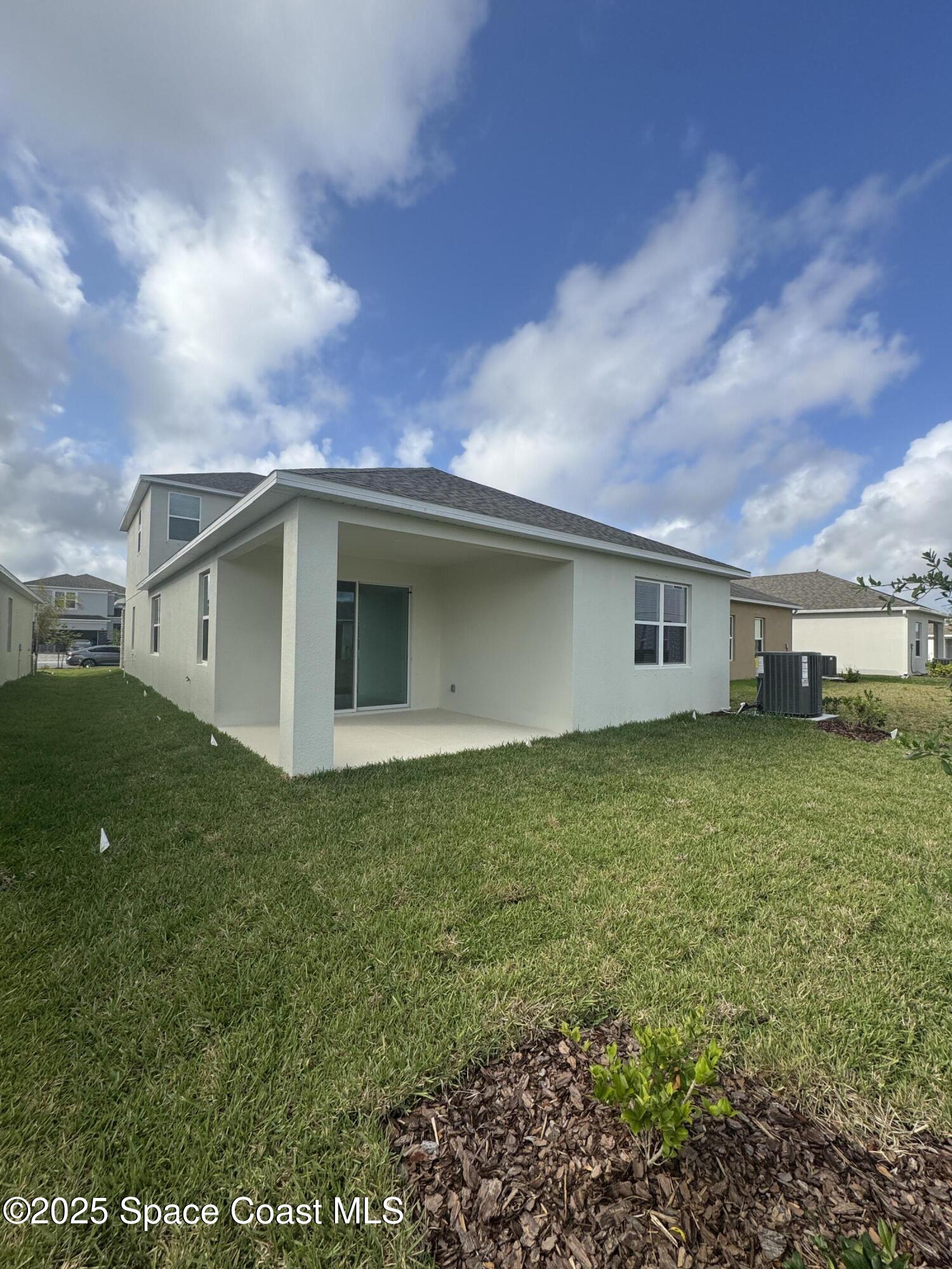 1041 Canfield Circle Palm Bay, FL 32909 - Photo 49 of 57 a backyard of a house with lots of green space