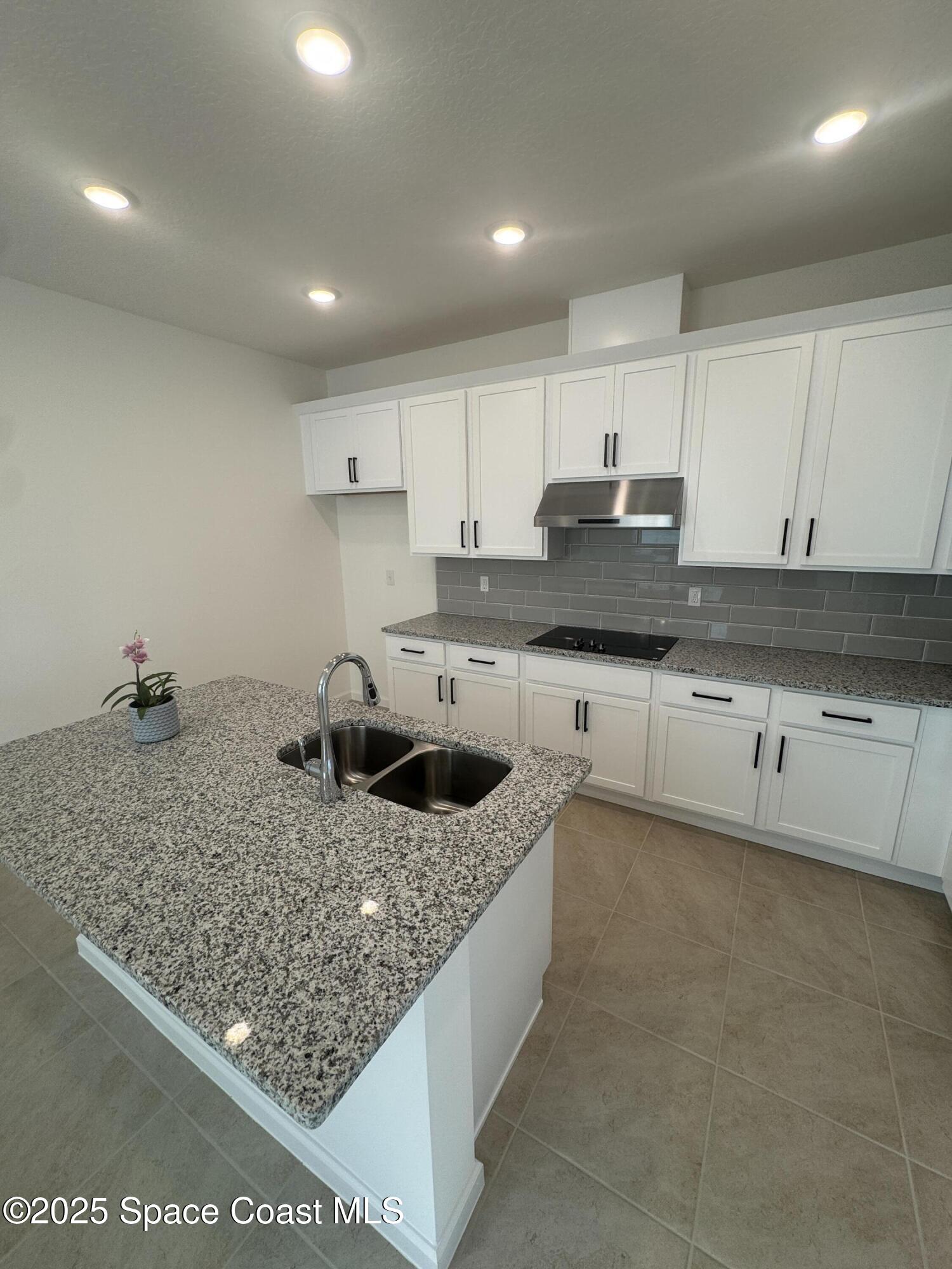 1041 Canfield Circle Palm Bay, FL 32909 - Photo 9 of 57 a kitchen with stainless steel appliances granite countertop a sink stove and cabinets