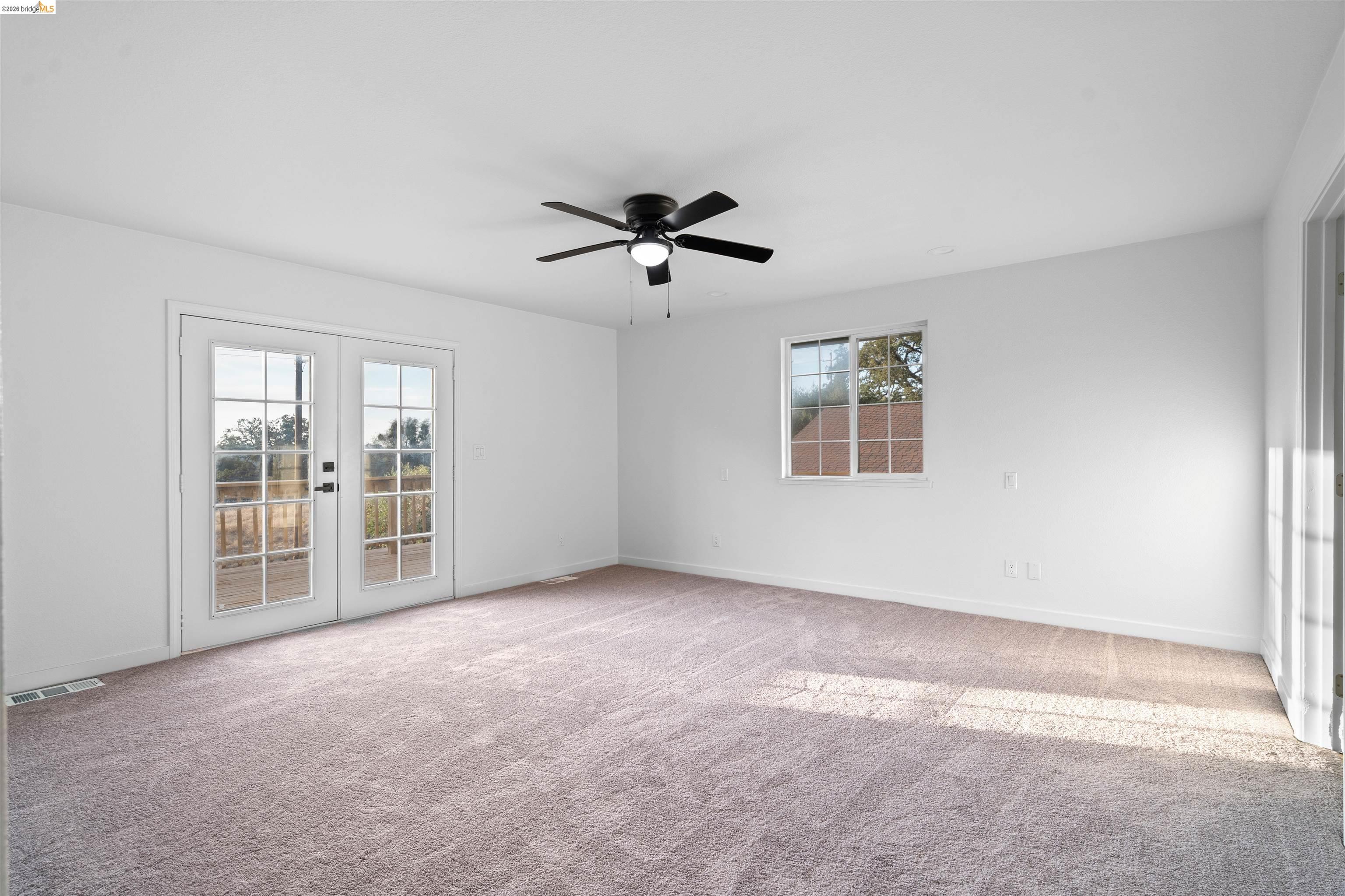 19676 Rawhide Road Sonora, CA 95370 - Photo 26 of 67 Plush carpeting, white walls, and a ceiling fan with integrated lighting