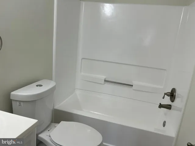 a bathroom with a toilet and a bathtub