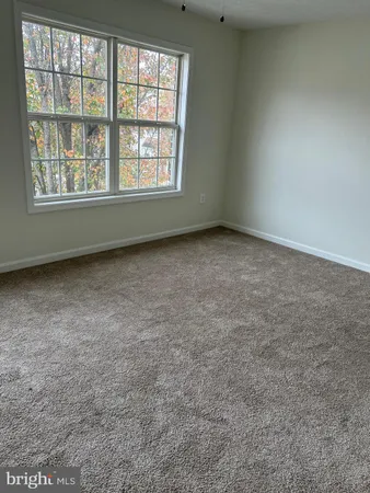 an empty room with closet and a chandelier fan