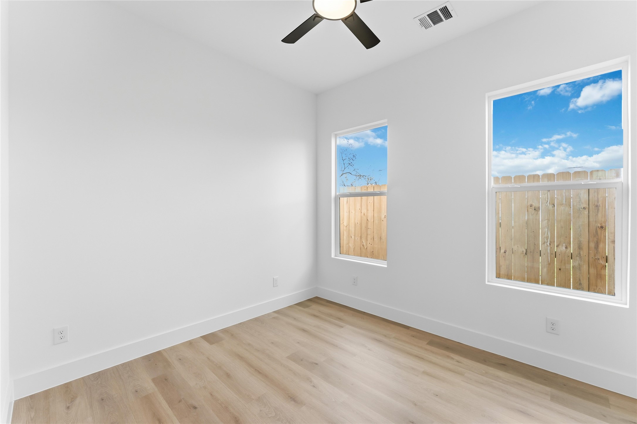 5423 Manton Street, Unit AB Houston, TX 77028 - Photo 13 of 25 an empty room with a window and ceiling fan