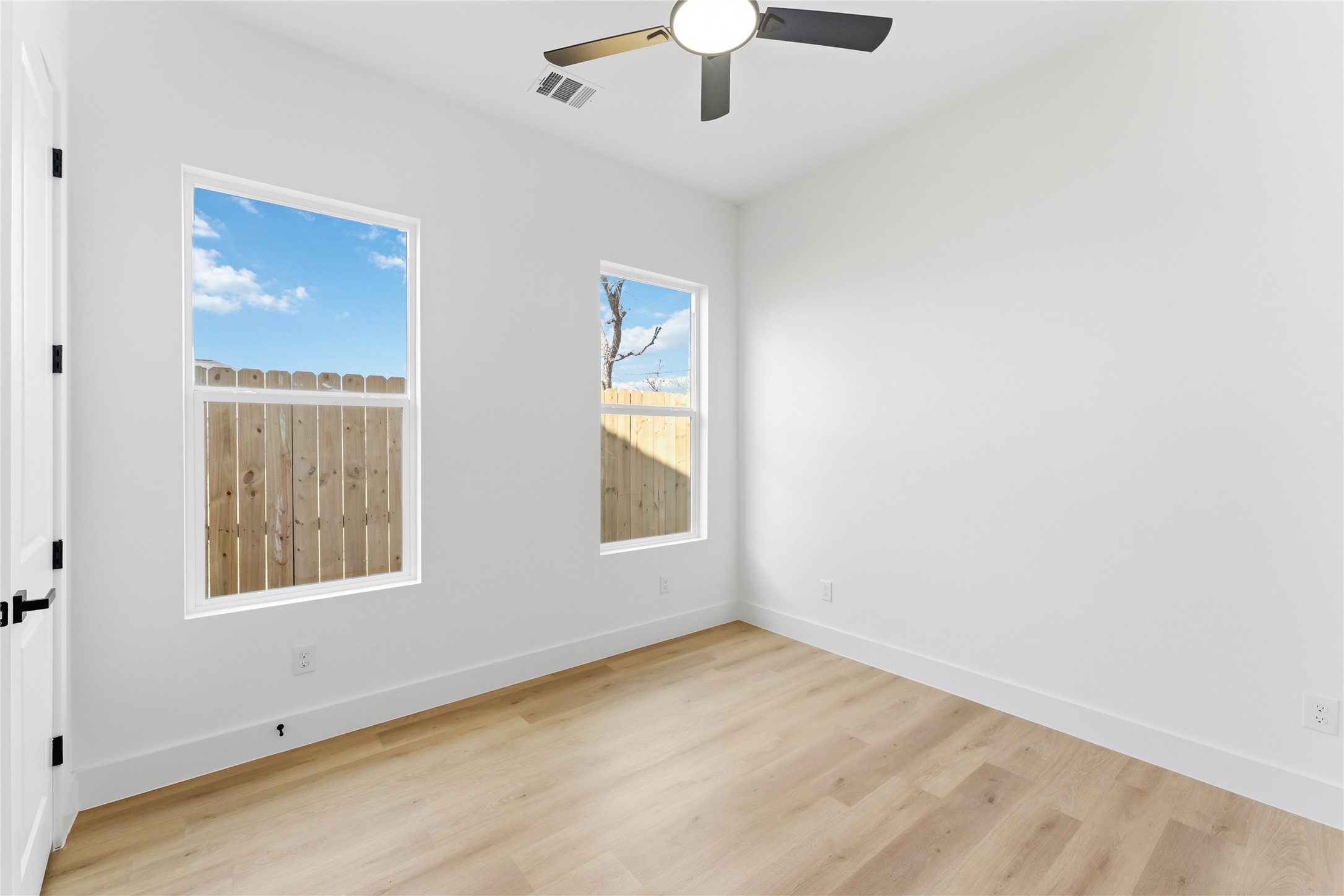 5423 Manton Street, Unit AB Houston, TX 77028 - Photo 16 of 25 an empty room with a window and a chandelier fan