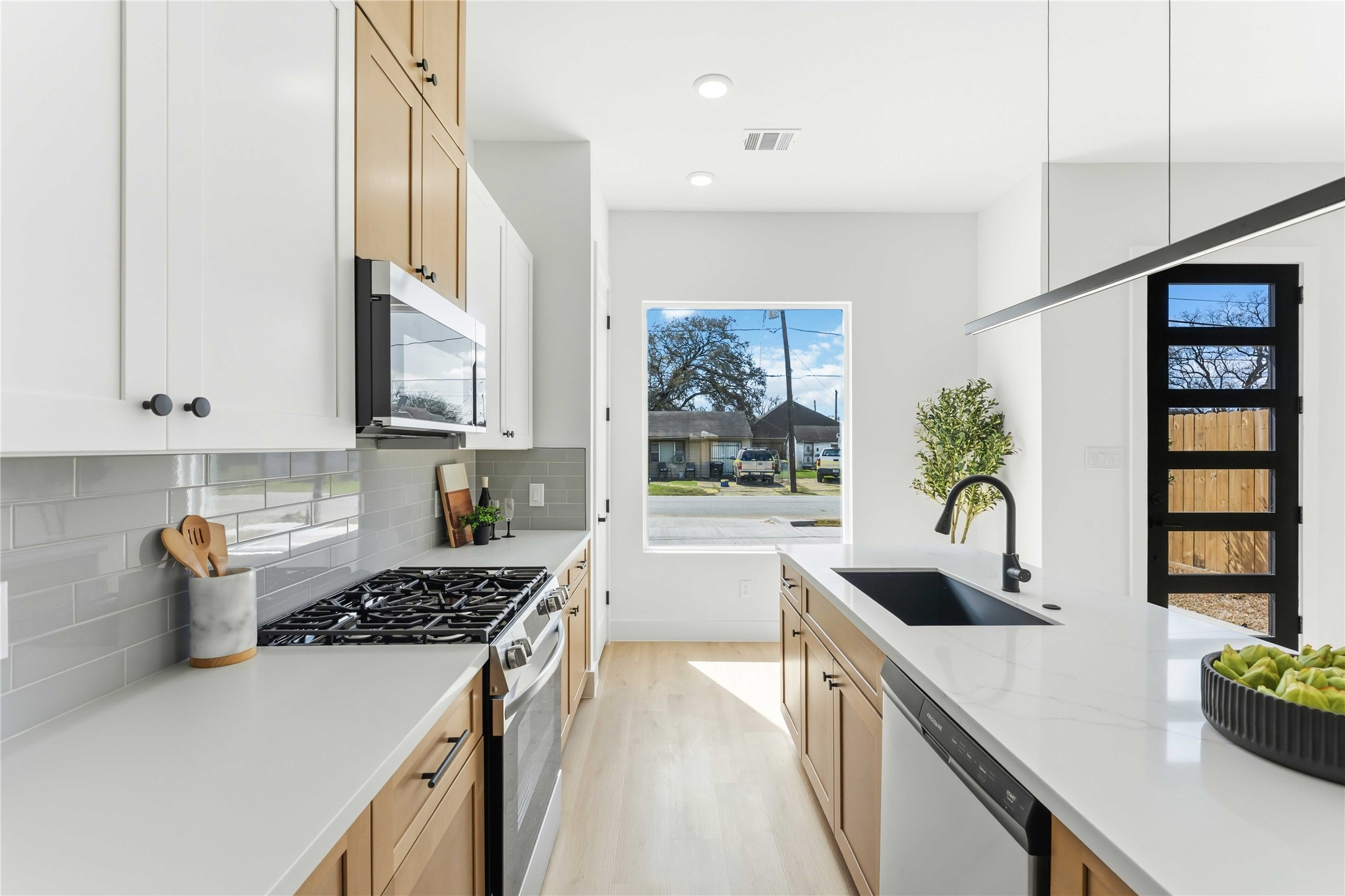 5423 Manton Street, Unit AB Houston, TX 77028 - Photo 10 of 25 a kitchen with stainless steel appliances granite countertop a sink stove refrigerator and cabinets