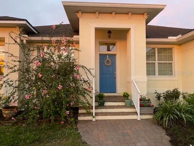 a view of a patio with table and chairs under an umbrella