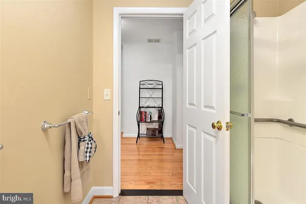 a view of a hallway with wooden floor and entryway