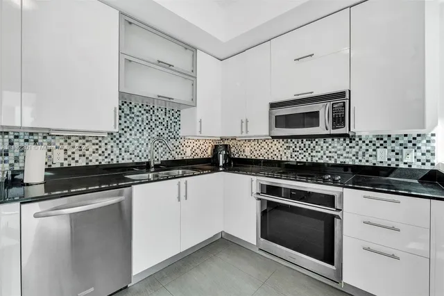 a kitchen with a refrigerator stove and microwave