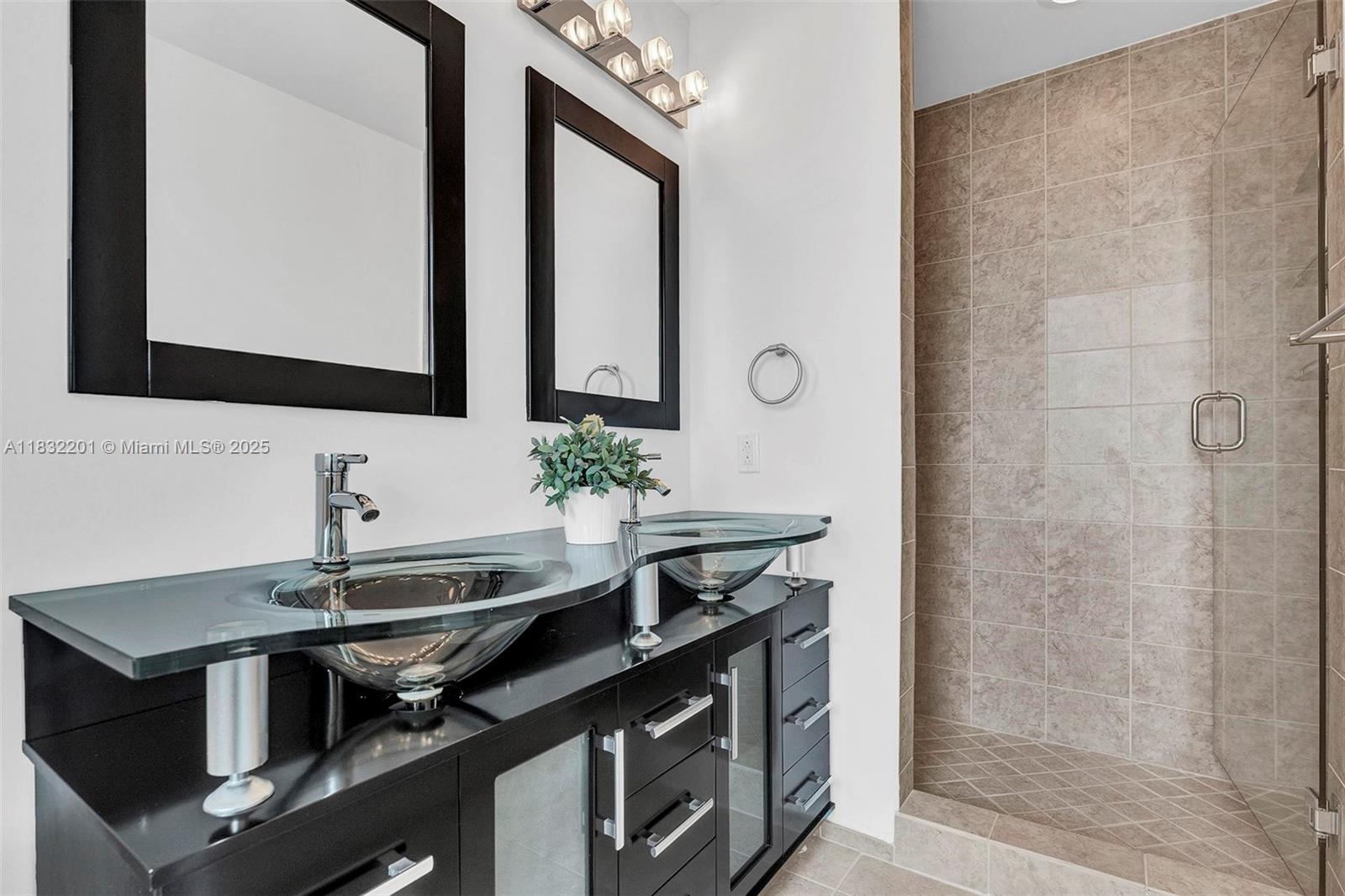 60 Southwest 13th Street, Unit 3400 Miami, FL 33130 - Photo 18 of 50 a sink a mirror and a shower