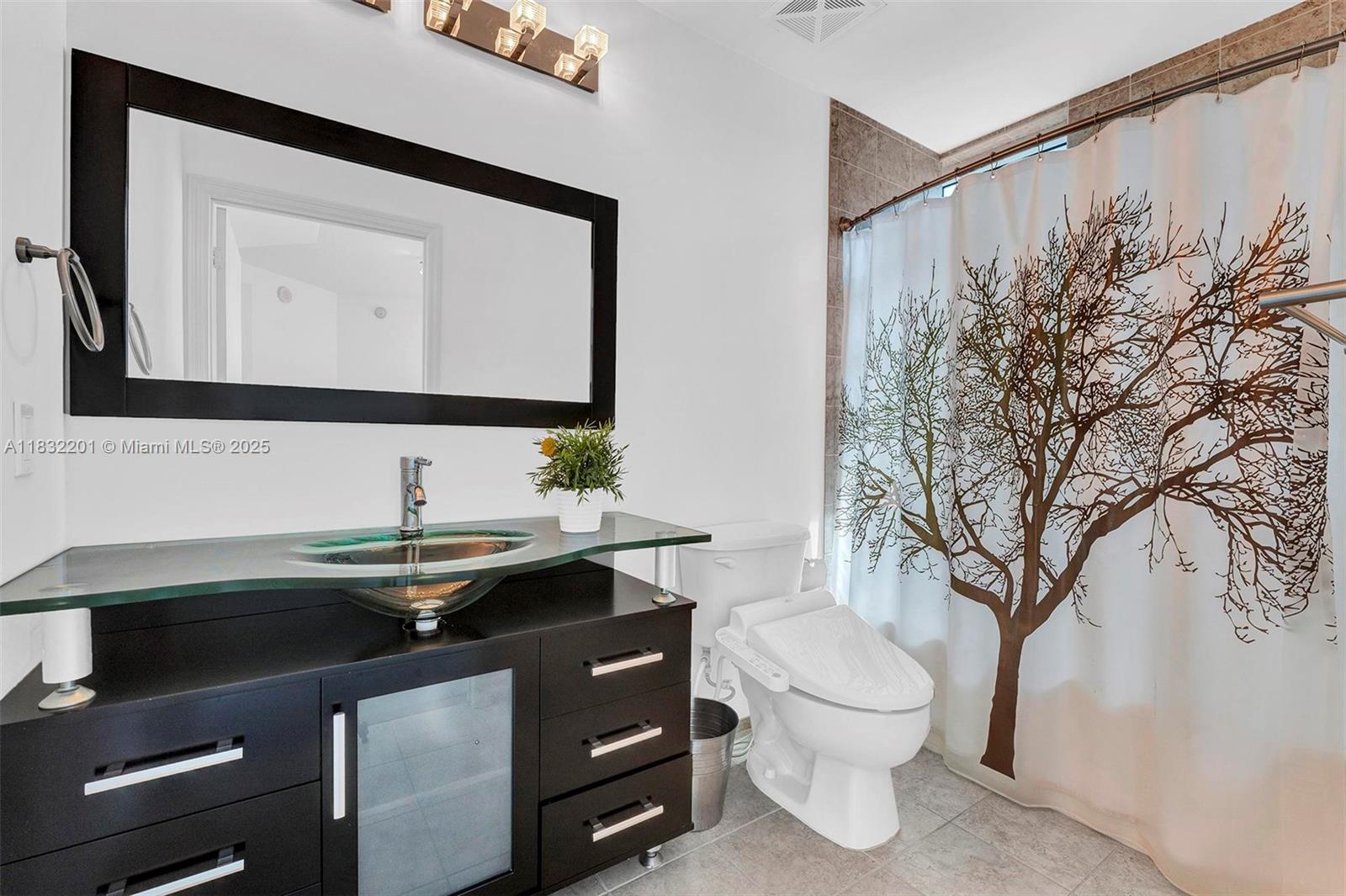 60 Southwest 13th Street, Unit 3400 Miami, FL 33130 - Photo 23 of 50 a bathroom with a toilet sink and mirror