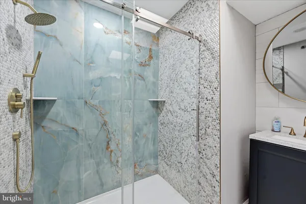 a bathroom with a shower and a sink